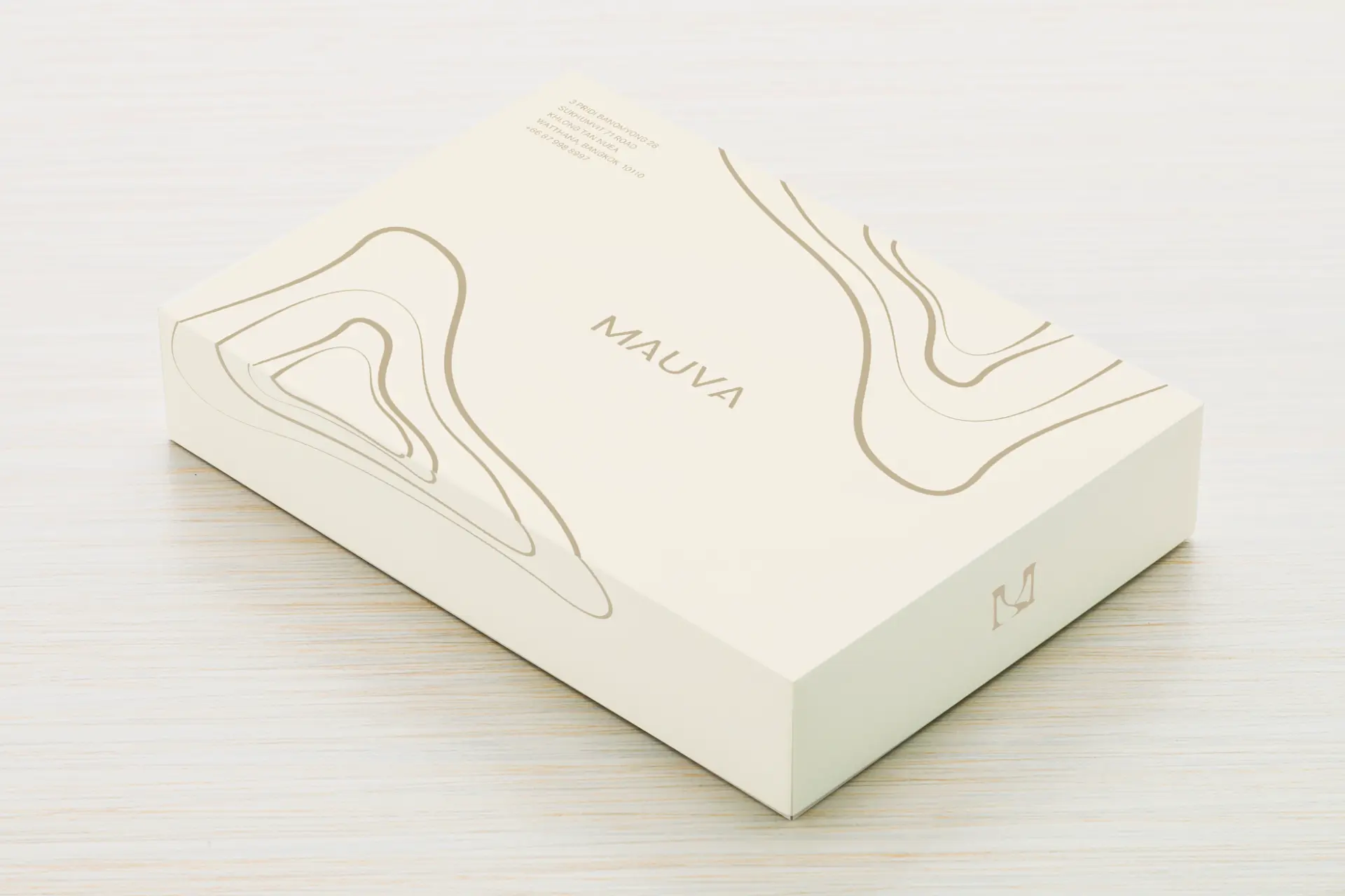 Mauva packaging box in cream with line-drawn garment illustrations and the M monogram