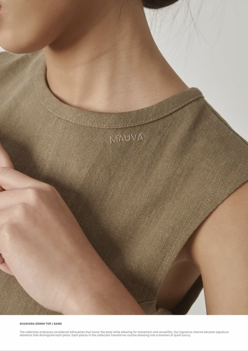 Mauva logotype embroidered on the neckline of a sand denim top